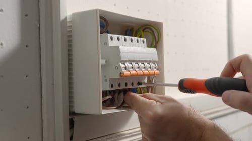 Electrician Assembles Electrical Panel