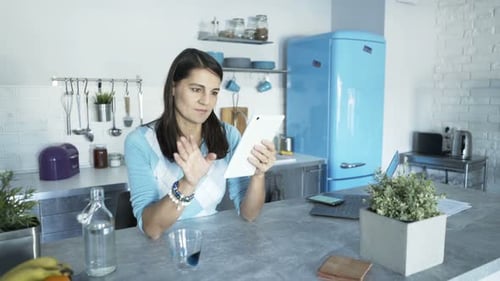 Woman Using Tablet Device in Modern Kitchen