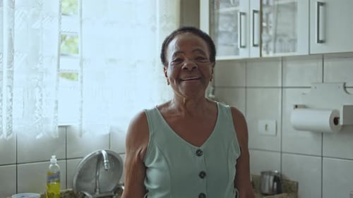 Smiling Senior Woman Portrait in Bright Kitchen