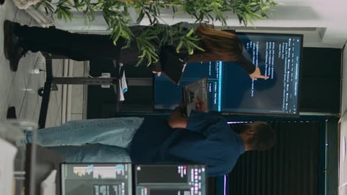 Vertical Video Diverse Team of System Developers Analyzing Code on Big Tv Screen