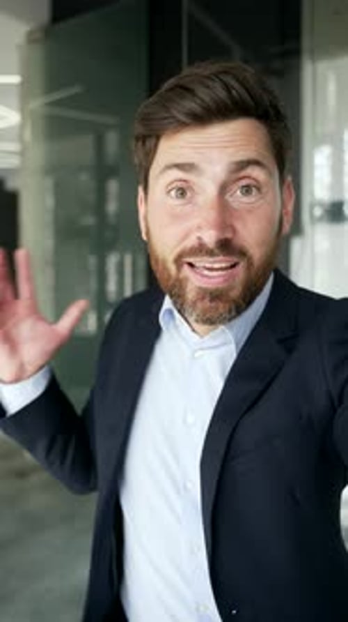 Cheerful Businessman Talking and Gesturing in Office