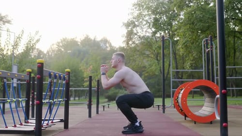 Fit Young Man with Naked Torso in a HighIntensity Outdoor Workout