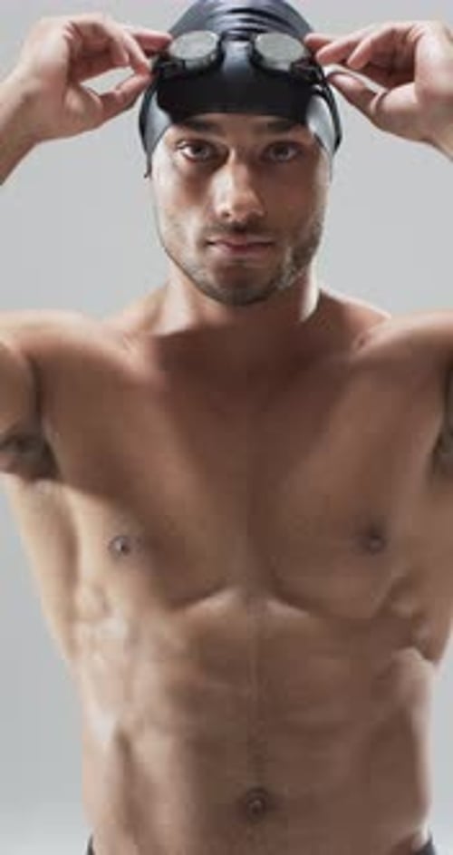Muscular Swimmer Adjusting Goggles, Portrait