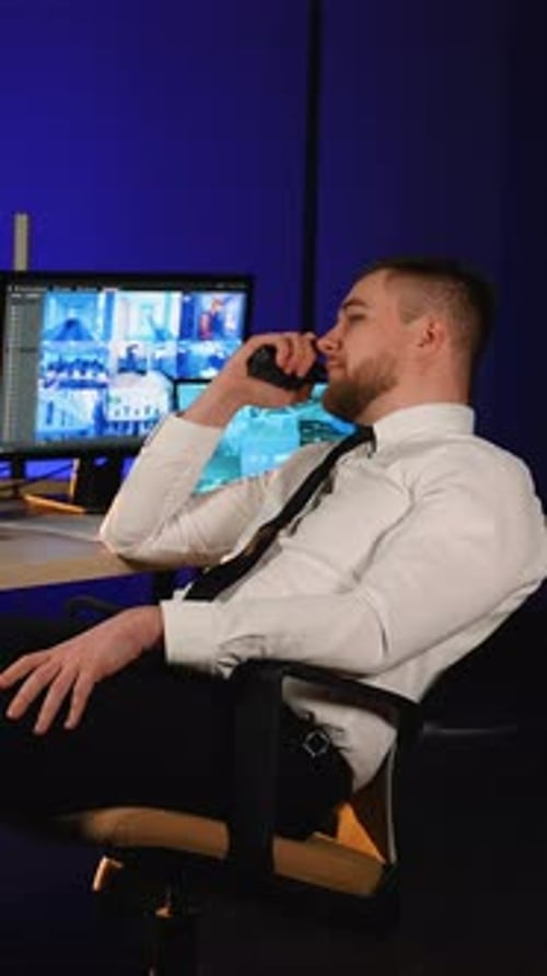 Man in Security Room Talks on Radio