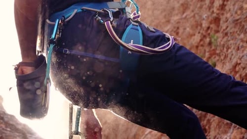 Sportsperson rock climbing in slow motion at a wall rock