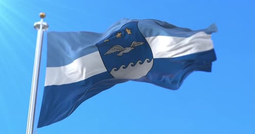 Realistic Waving Flag with Shield Emblem Against Blue Sky