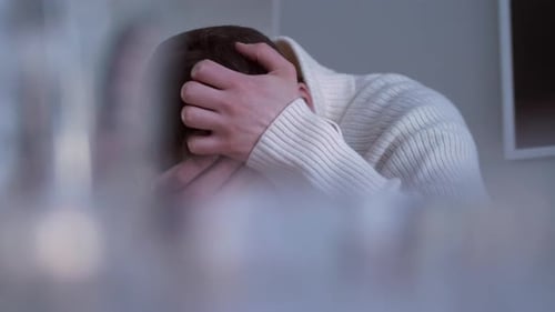 Man with Head in Hands Expressing Stress