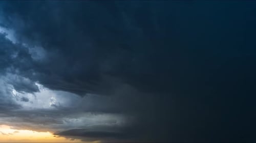 Dramatic sunset with dark storm clouds approaching