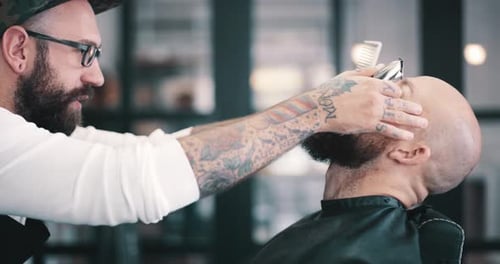 4k video footage of a young man getting his beard trimmed at a barbershop