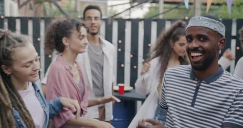 Friends Dancing at an Outdoor Daytime Party