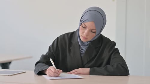 Arab Businesswoman Doing Paperwork in Office