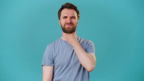 Man Grips Sore Throat and Wipes Runny Nose