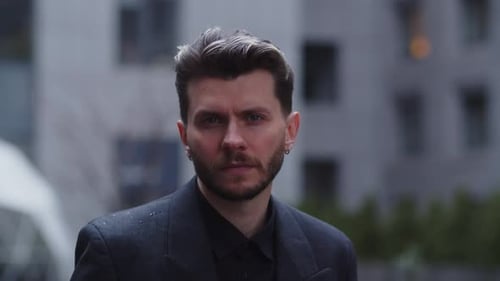 Man in Suit Standing in the Rain