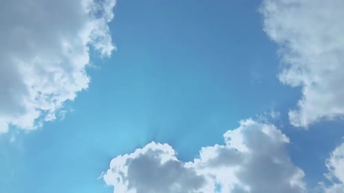 Clouds Passing in a Bright Blue Sunny Sky
