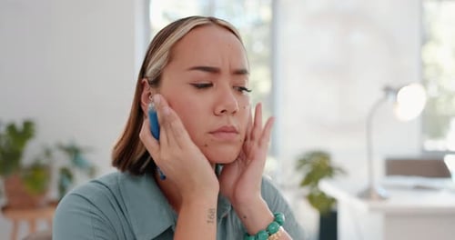 Headache, pain and burnout business woman overworked and thinking in her office feeling stress