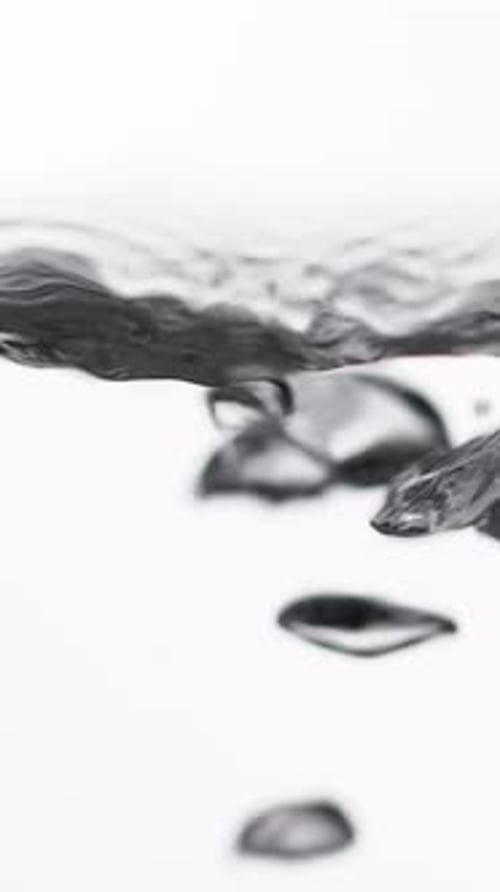Boiling Water Bubbles Rising Up on Surface Closeup Vertical