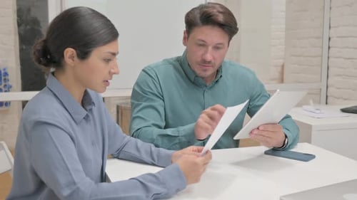 Coworkers Working Together in Office with Tablet