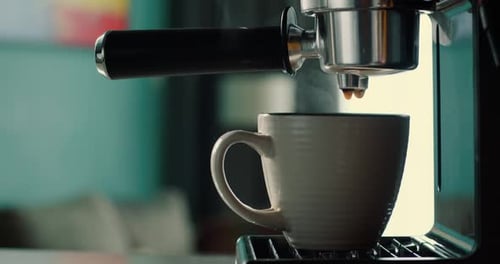 Pouring Coffee Stream From Machine in Cup Home Making Hot Espresso Using Filter Holder Flowing Fresh