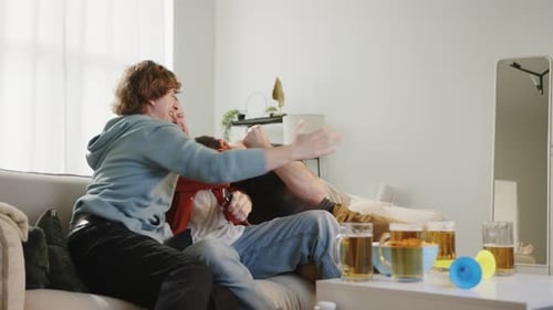 Friends Cheering for Sports Team in Living Room