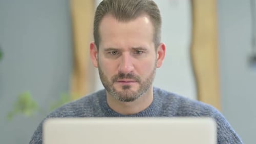 Close Up of Mature Adult Man Reacting to Loss on Laptop