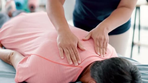 Physiotherapy, back massage and chiropractor with senior woman in medical office at clinic