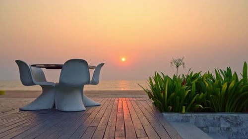 empty outdoor patio chair and table with sea beach background