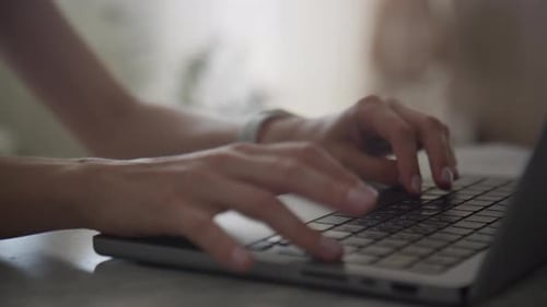 Hands Typing on Laptop Keyboard Close Up