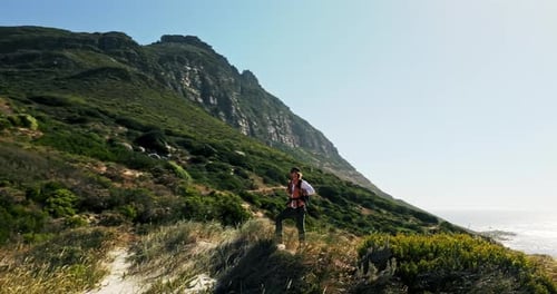 Drone, man outdoor and hiking with celebration for travel adventure, achievement and beach scenery