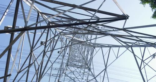Power Lines Towering Against Clear Blue Sky