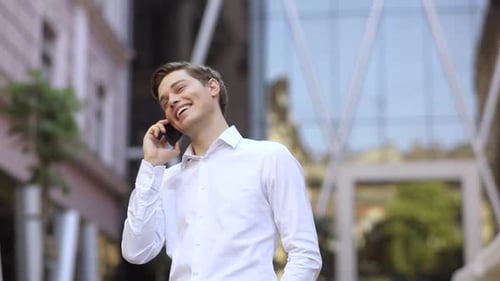 Happy Successful Business Man Speak on Phone Use Mobile on the City Business District Street