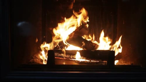 Heating, Warmth, Fire and Cosiness Concept - Close Up of Firewood Burning