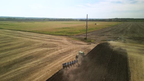Tractors plowing the field in Ukraine