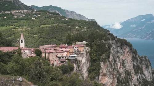 City on Cliffside Overlooking Lake and Distant Mountains