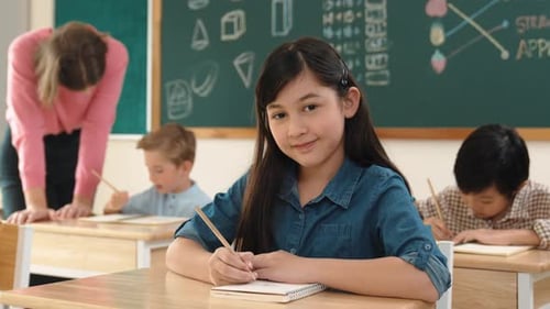 Elementary School Students Working at Desks in Classroom