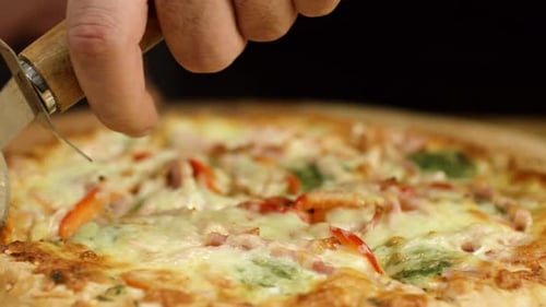 Pizza Chef Slicing Pizza on Wooden Board
