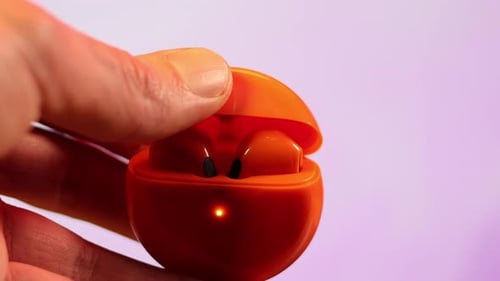 Hand Opens Wireless Earbud Charging Case