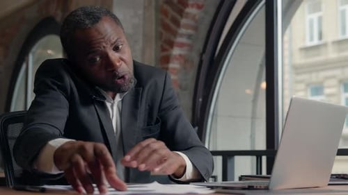 Man Working at Laptop in Modern Office