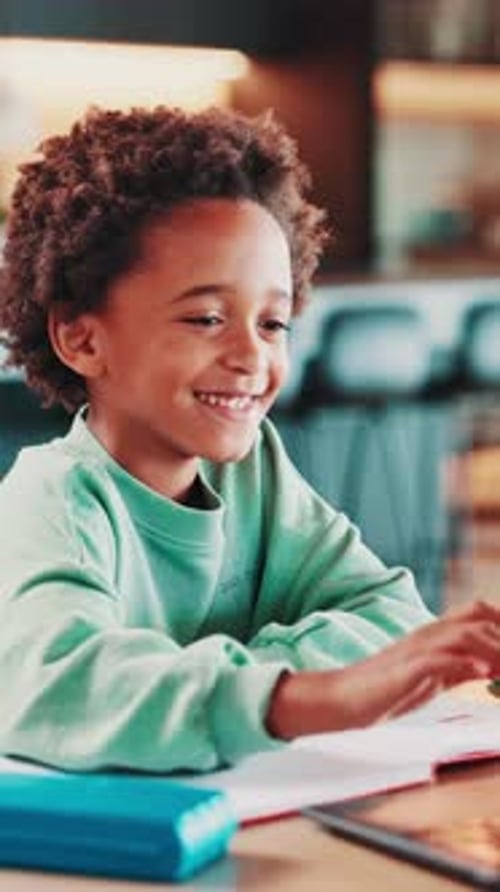 Smiling Boy Doing Homework in Bright Indoor Light
