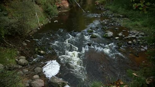 Very Beautiful Rocky River Landscape with Red Rock Outcrops and Small Rapids
