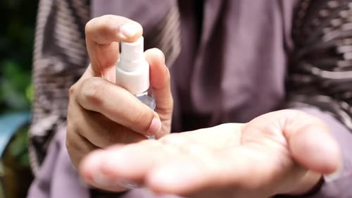Close Up of Young Women Hand Using Hand Sanitizer Spray