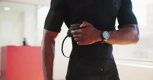 Hands, person and ems fitness in gym with electric muscle stimulator for strength training