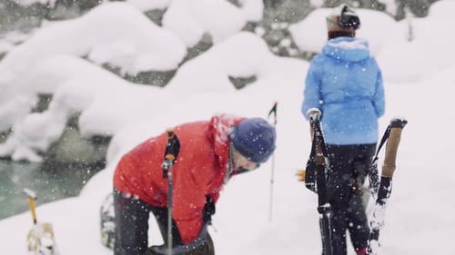 People Exploring Snowy Wilderness in Winter with Skis