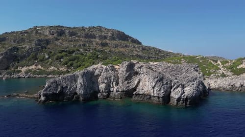 Aerial View of Rocky Coastline on Bright Day