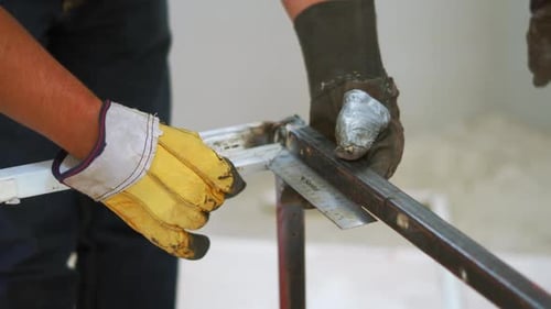 Hands Of A Metalworker Measuring Steel For Fabrication With L-shaped Angle Ruler. close up