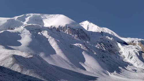 panoramic view of thorung la pass covered by snow during a sunny day himalayan mountains nepal, famo