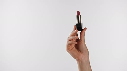 Elegant Hand Holding Luxurious Pink Shade Lipstick Tube