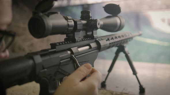 Shooter reloading sniper rifle at shooting range, close up on weapon ...