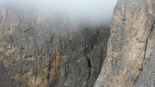 Aerial scene at mountainous landscape flying towards rocky structures. Mountains of Dolomites, Ita