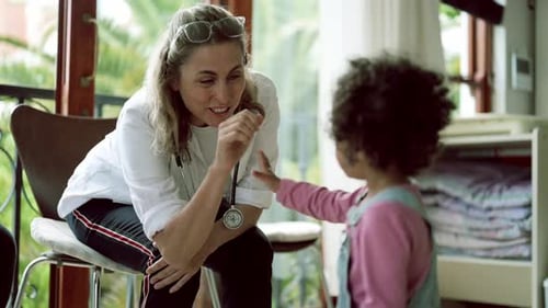 Doctor, high five and fist bump with child at hospital for healthcare consultation