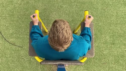 A male athlete works out at the outdoor gym